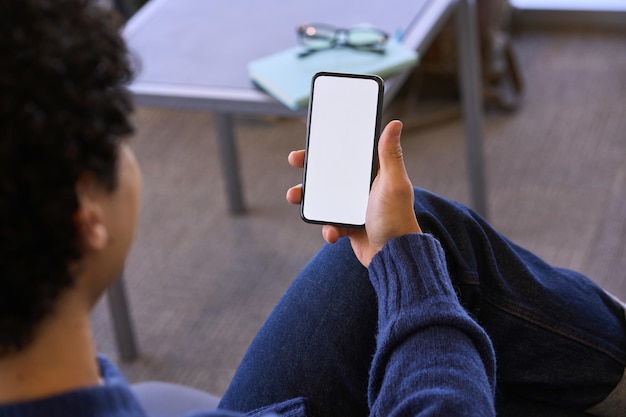 Man holding smartphone with blank copy space screen for your text message or information content