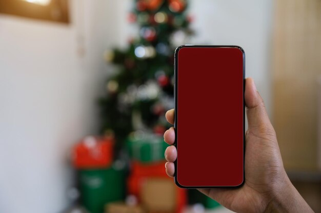 Man holding smartphone with Viva Magenta screen closeup of hands Space for text