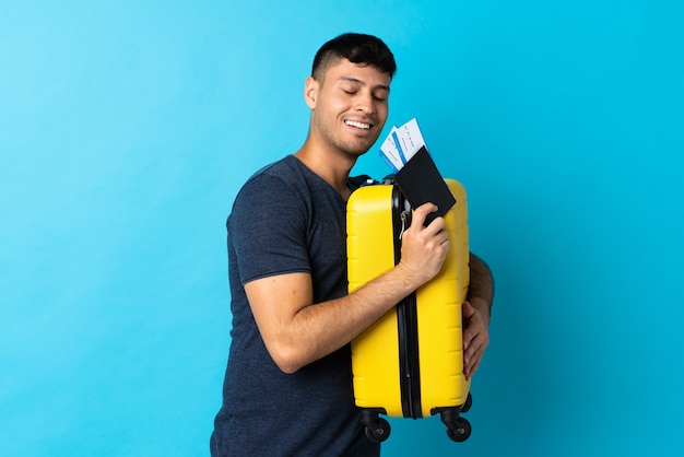 Man holding a suitcase in studio