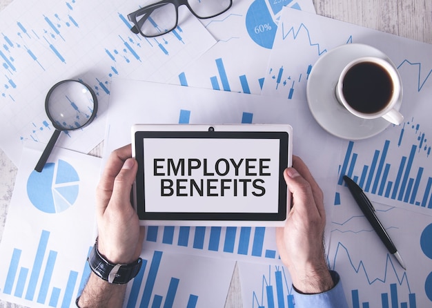 Man holding tablet computer with a Employee Benefits text.