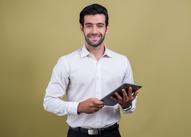 a man holding a tablet in front of a yellow background.
