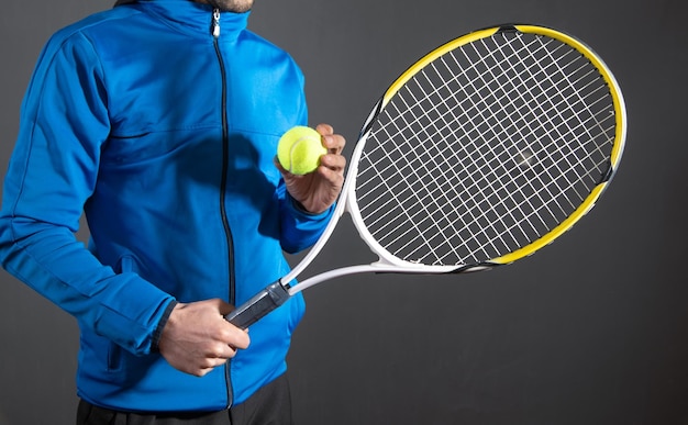 Man holding tennis ball and racket Sport Hobby