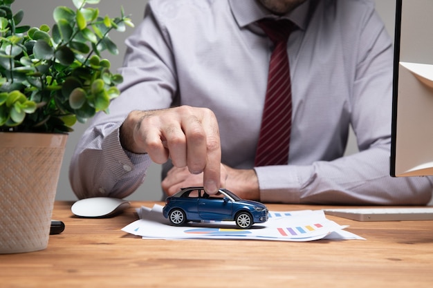 A man holding a toy car .