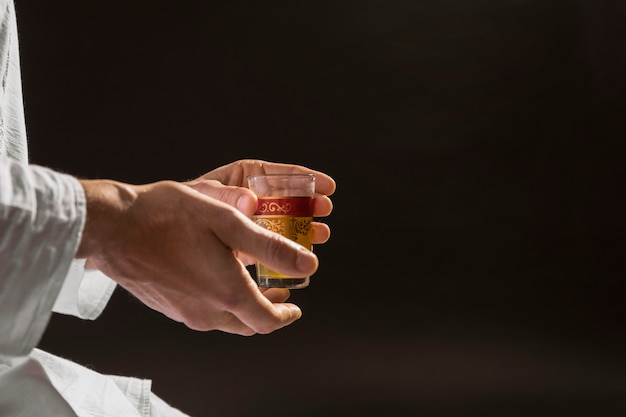 Man holding traditional tea black background