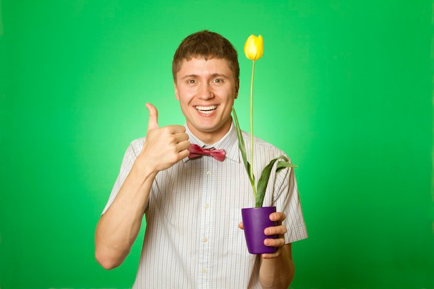 Man holding a tulip grown in a pot