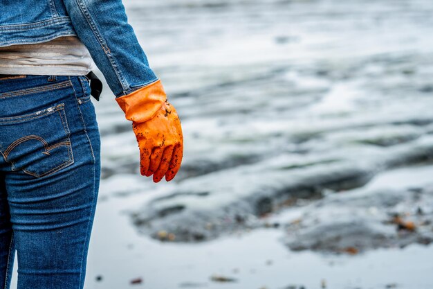 Man holding umbrella standing at beach