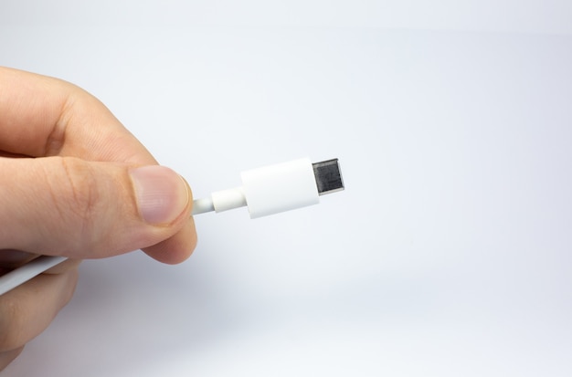 Man holding USB Type C Port Cable for charging. Close up photo.