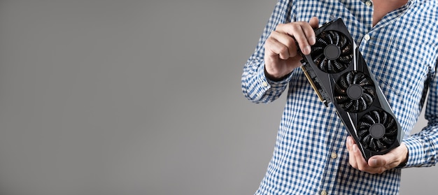 A man holding a video card.