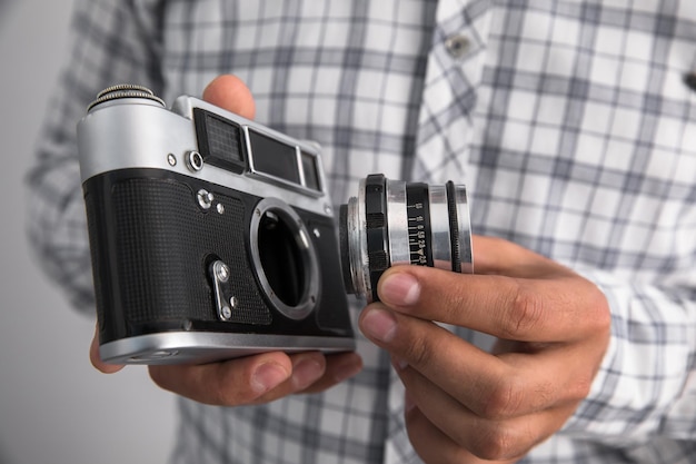 Man holding vintage camera with lens