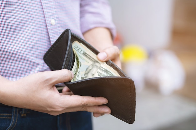 Man holding a wallet with money