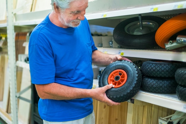 Man holding wheel while working in workshop