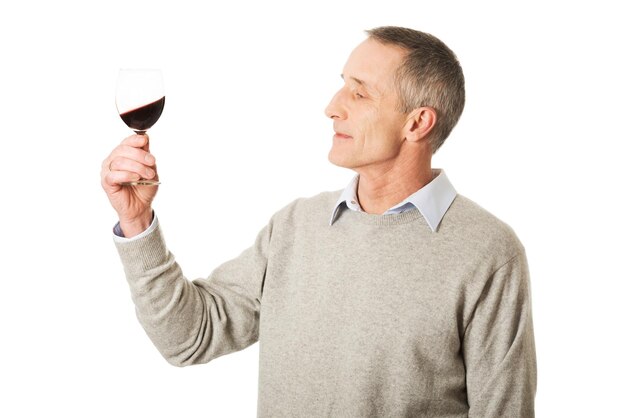 Man holding wineglass against white background