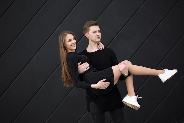 Man holding woman hands on black background