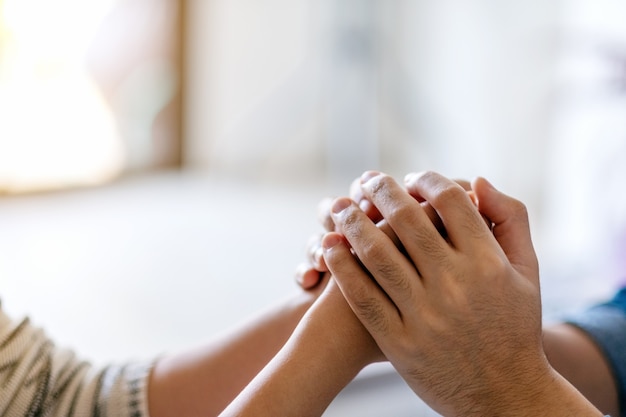 A man holding a woman's hands to show love and care