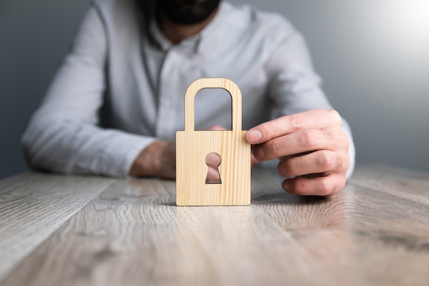 Man holding wooden lock