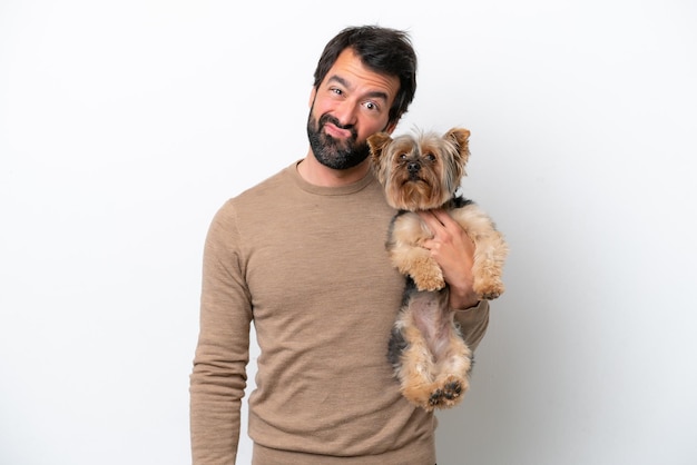 Man holding a yorkshire isolated on white background with sad expression