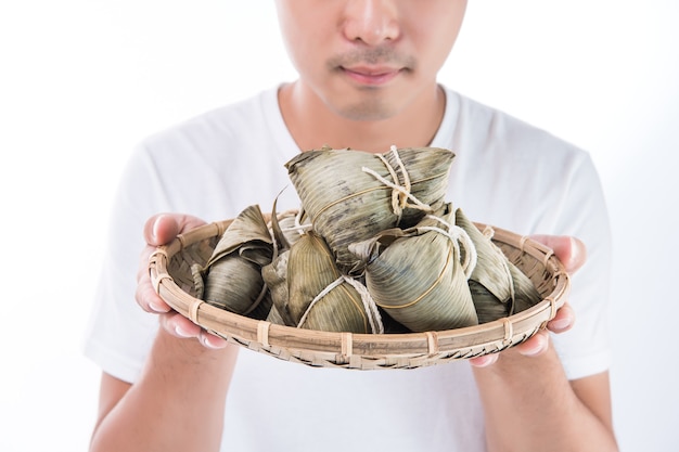 A man holding zongzi, rice dumpling for Dragon Boat Festival