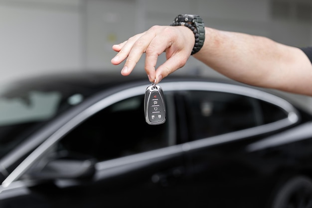 man holds car keys Car rental and purchase Transport sales