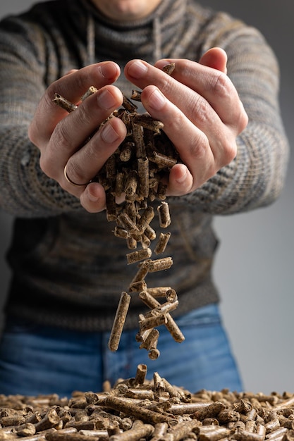 A man holds a chain of raw straws in his hands