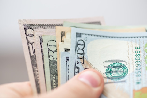 Man holds dollar bills in his hand close up macro shot