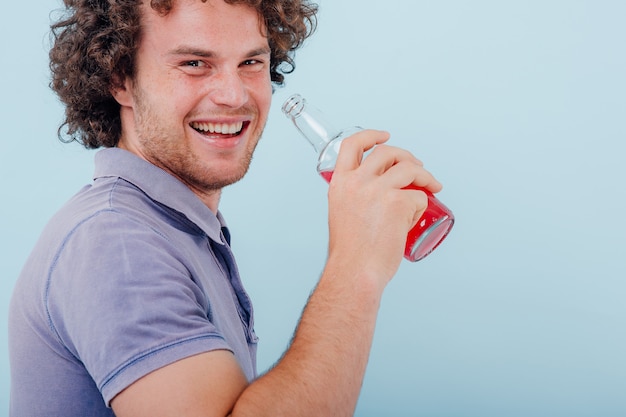 man holds in his hand bottle of drink