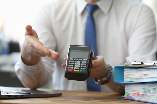 Man holds his hand wireless terminal for payment