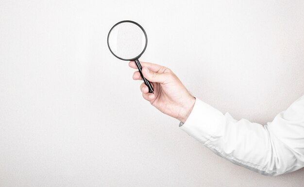 Man holds magnifying glass