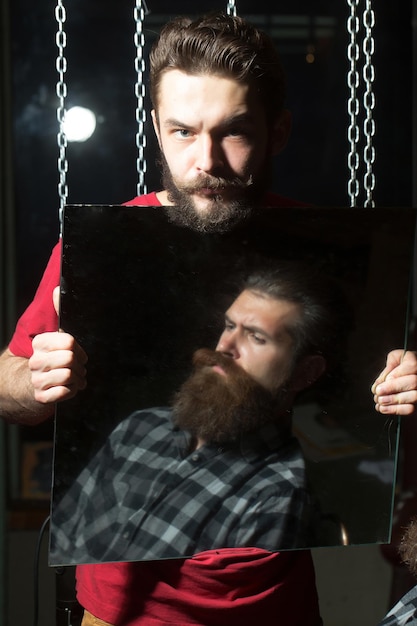 Man holds mirror reflecting customer