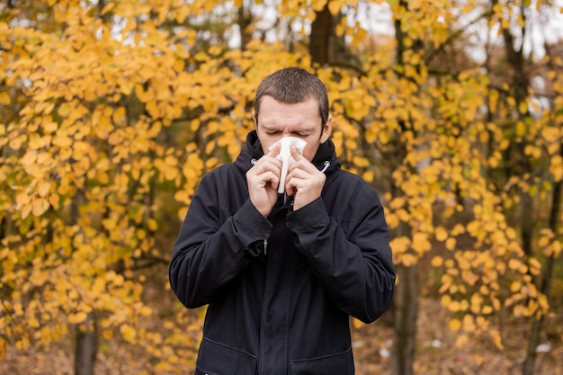 A man holds a napkin near his nose