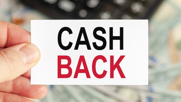 Photo a man holds a piece of paper with the text: cash back