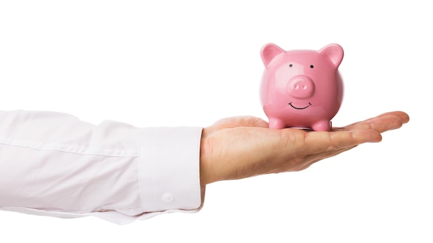 Man holds a piggy bank on his palm, isolated on a white background, template for designers