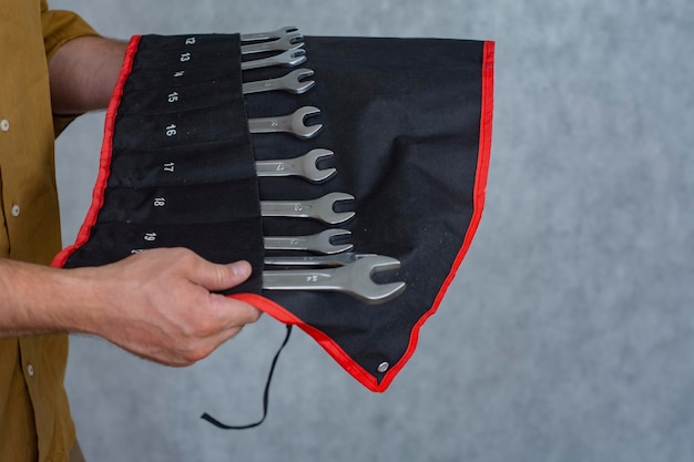 Man holds a set keys for car repair.