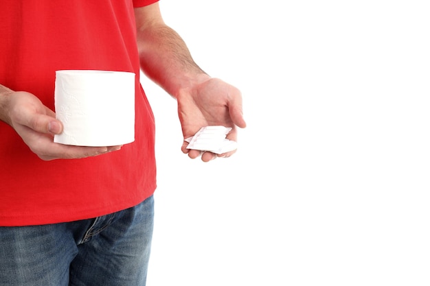 Man holds toilet paper and suppositories, isolated on white background. Hemorrhoids concept