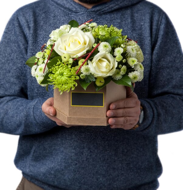 Man holds white rose in a cardboard box Valentine's Day