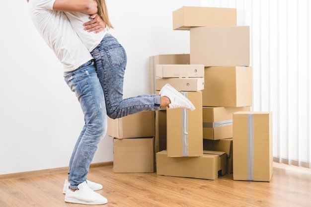 The man holds the woman the background of the carton boxes