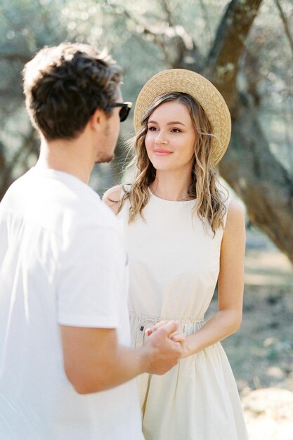 Man holds a woman hand in an olive grove Closeup