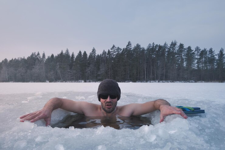 Photo the man in the hole. winter swimming and a healthy lifestyle