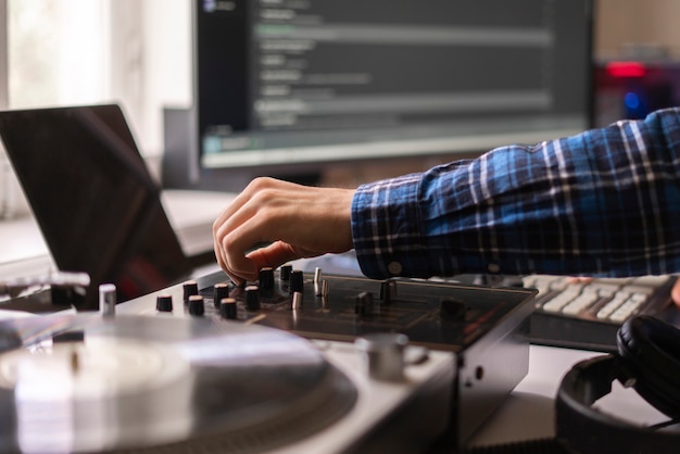 A man in the home music studio, creating new song, making sound production with vintage equipment