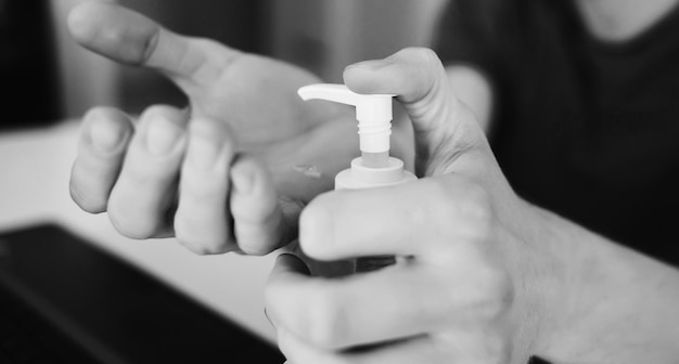 Man at home puts an antibacterial gel on his hands no bacteria