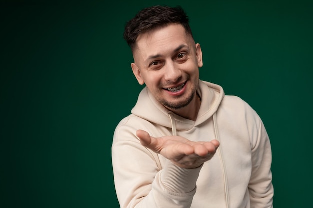 A man in a hoodie making a hand gesture