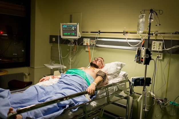 Man on hospital bed for recovery