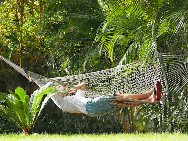 Man in a hotel lying in a hammock