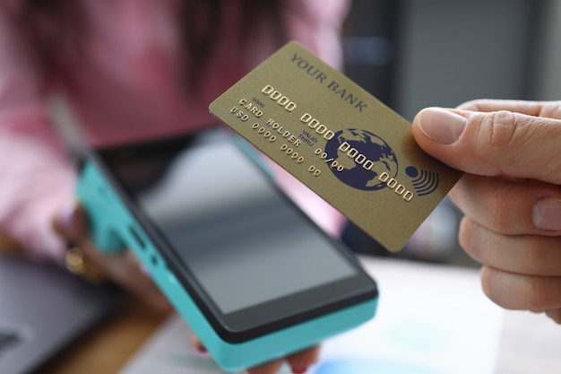 Man houdt creditcard met PayPass-technologie