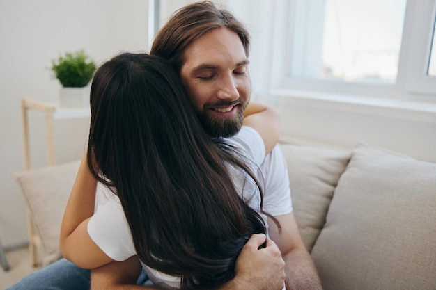 The man hugs the girl and smiles The joy of using the family and the good psychological state after the quarrel