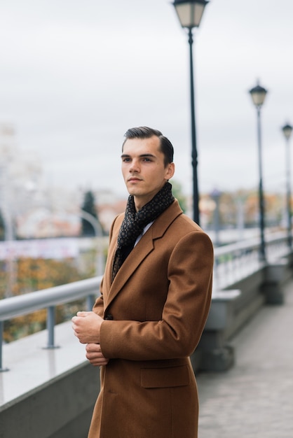 Man in een stijlvol pak. Zakenman in een herfststad, mode