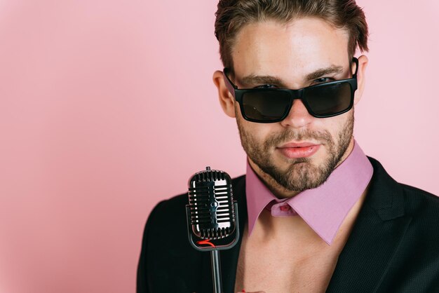 Beautiful Caucasian Man with Glasses Sings Songs in Karaoke with Microphone Isol