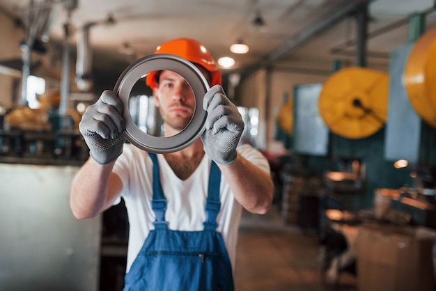 Man in uniform werkt aan de productie