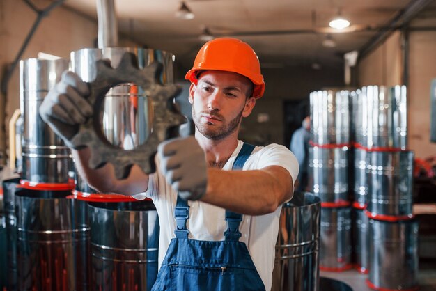 Man in uniform werkt aan de productie