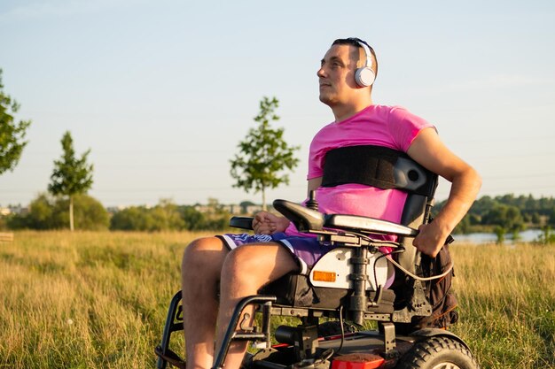 Фото Человек в инвалидном кресле слушает любимую музыку в наушниках