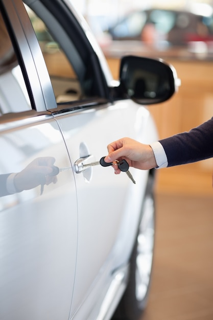 Man inserting a car key in the lock